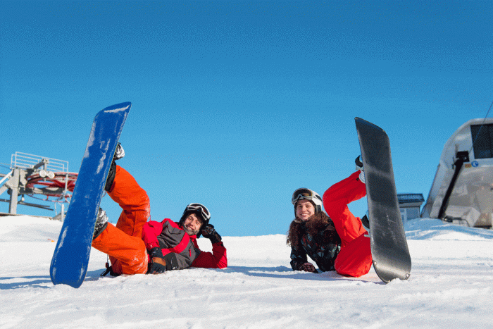 Deux personnes sur la neige en snowboard
